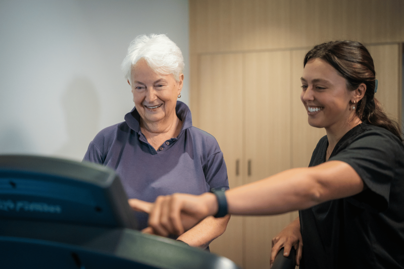 Physio with older female on treadmill